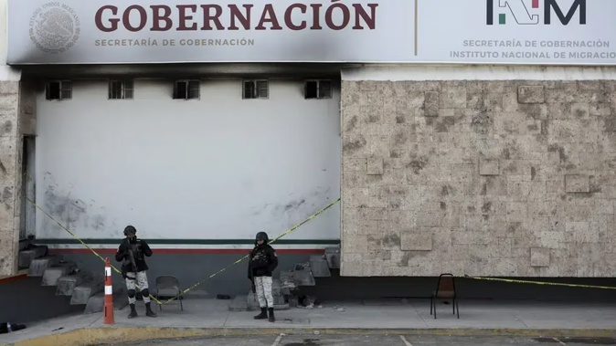 Police stand guard outside a Mexican immigration detention centre in Ciudad Juarez, Mexico. Photo / AP