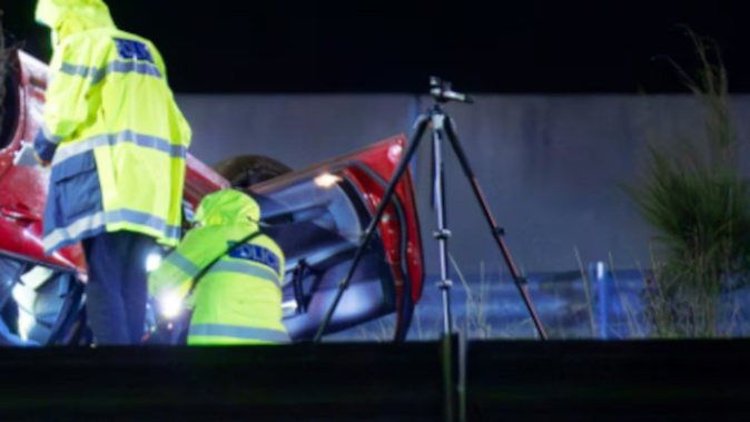 The car rolled onto its roof on the Northwestern Motorway. Photo / Hayden Woodward