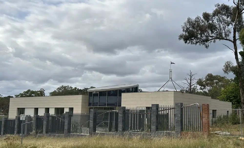 The Australian flag flies on Parliament House, seen behind an unoccupied building on the grounds of a proposed new Russian embassy near the Australian Parliament in Canberra, Feb. 28, 2023. Australia's House of Representatives passed legislation Thursday, June 15, 2023, to prevent Russia from building a new embassy near Parliament House on security grounds. (AP Photo/Rod McGuire)
