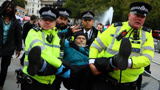 Police officers detain a demonstrator in Trafalgar Square during a protest in support of Palestine Action in London, England. Photo / Getty Images