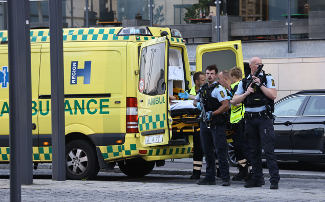 An ambulance and armed police outside the Field's shopping center, in Orestad, Copenhagen, Denmark, Sunday, July 3, 2022, after reports of shots fired. 