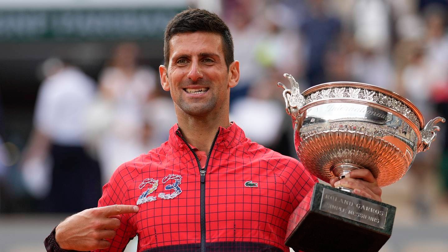 Serbia's Novak Djokovic points at 23 on his garment as he celebrates winning the men's singles final match of the French Open. Photo / AP