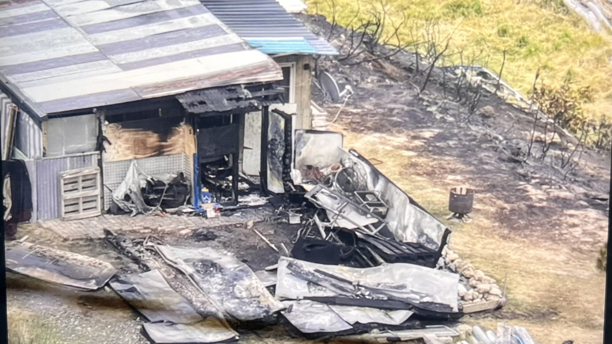 Man whose hillside home was scorched by fire faces wait to see damage inside
