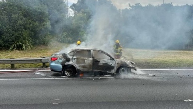 A fire has left the charred remains of a car on Auckland's Southern Motorway, creating major northbound traffic backlogs ahead of rush hour on Wednesday.