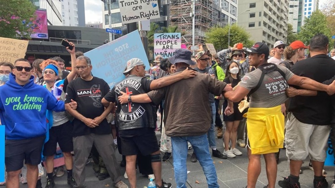 Destiny Church supporters link arms to keep counter-protesters out of Aotea Square. Photo / Dean Purcell