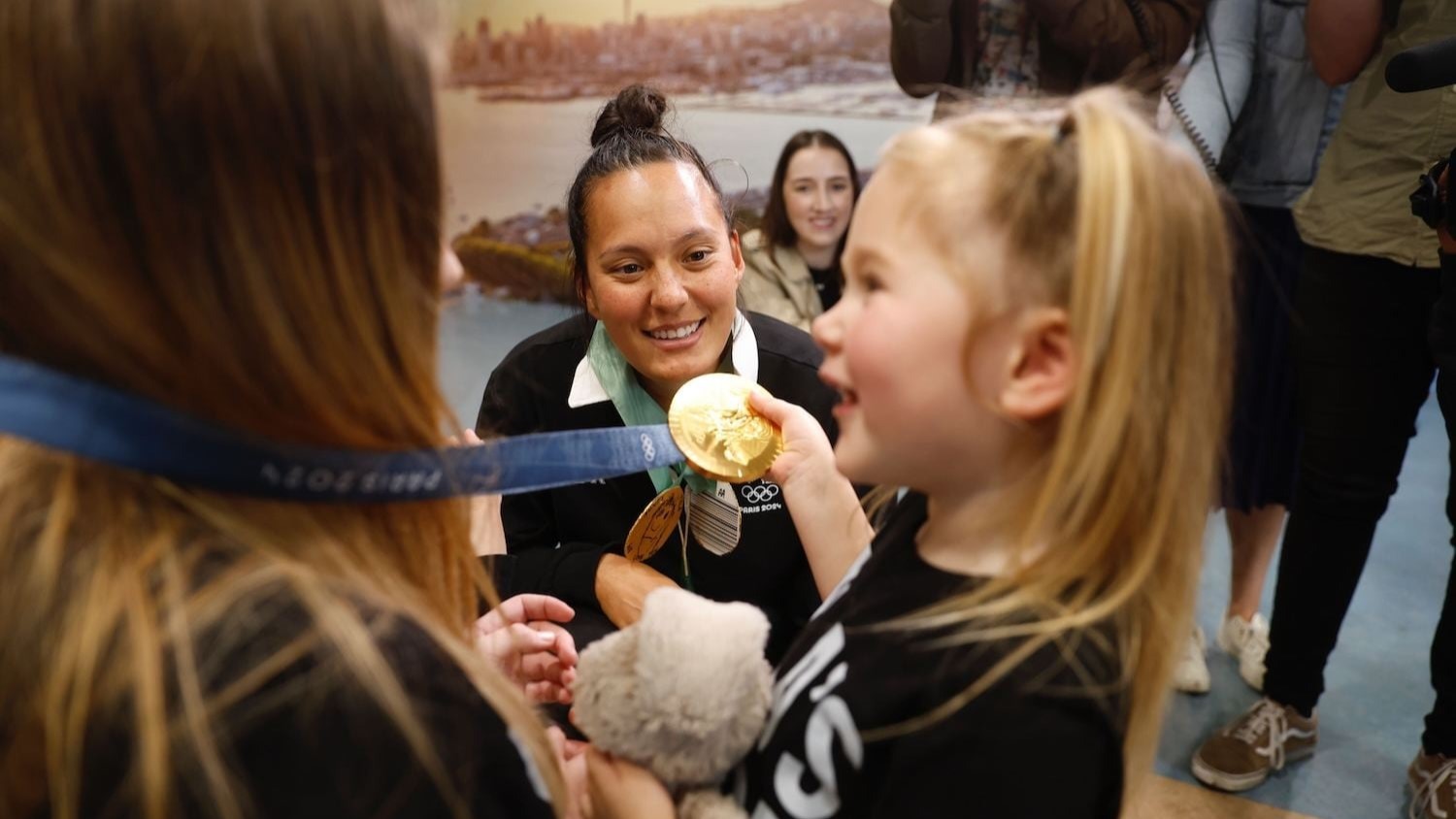Black Ferns Sevens star Tyla King speaks with supporters after returning to Auckland with her gold medal from the Paris Olympics. Photo / Michael Craig