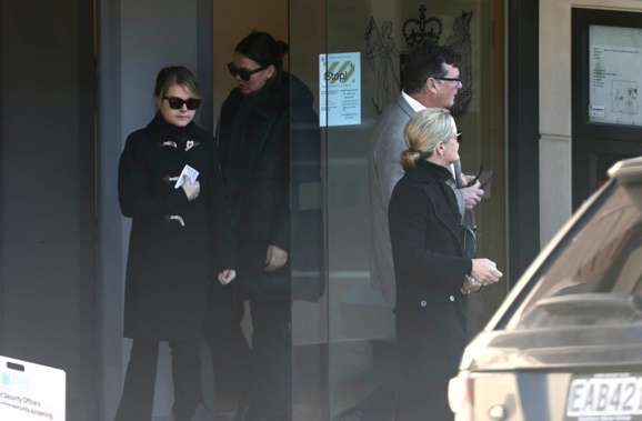 Isabel Tully Robinson (left), 22, leaves the Queenstown District Court supported by family members. Photo / George Heard