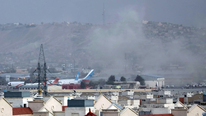 Smoke rises from a deadly explosion outside the airport in Kabul, Afghanistan. (Photo / Wali Sabawoon, AP)