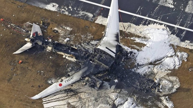 JAL 516 and a Japanese coast guard aircraft collided on the runway at Tokyo's Haneda Airport on Tuesday and burst into flames, killing several people aboard the coast guard plane, officials said. Photo / Kyodo News via AP