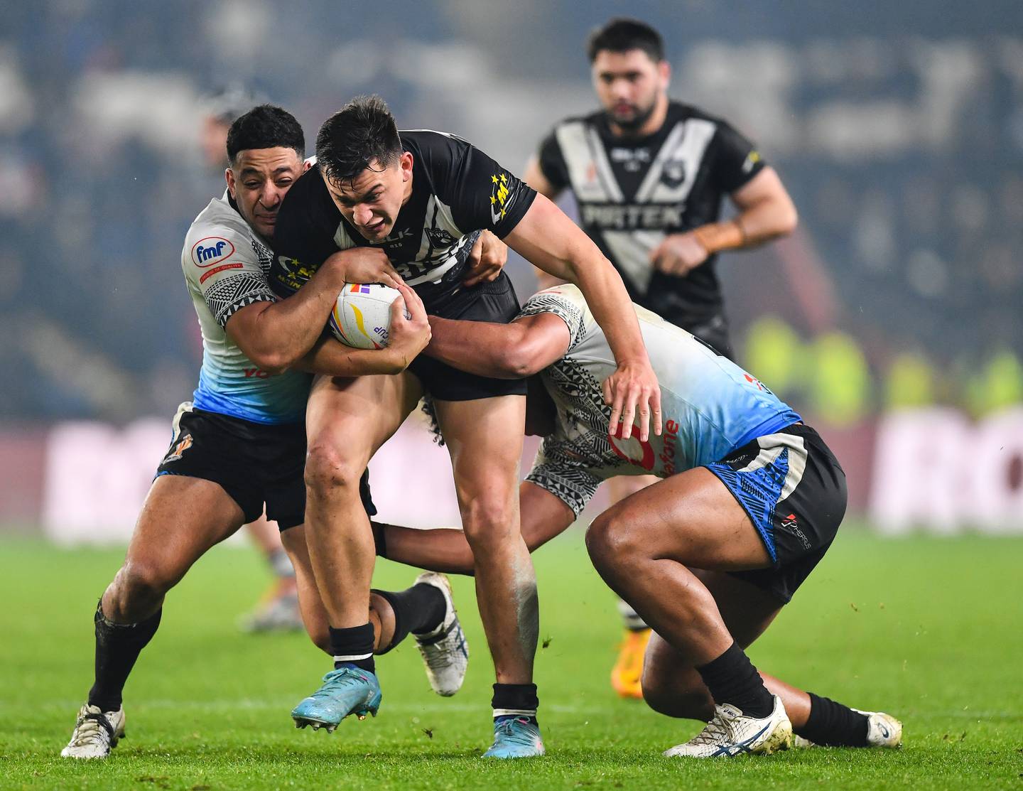 Joseph Manu of New Zealand is tackled by Tui Kamikamica and Siua Wong of Fiji. Photo / Photosport