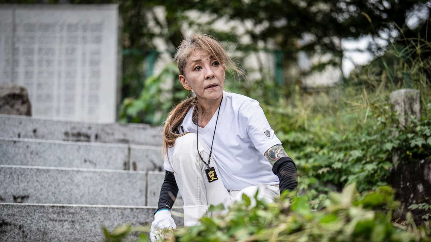 Retired yakuza Mako Nishimura sorts fallen leaves during a cleaning activity with right-wing group members at the Gifu Gokoku shrine in Gifu. Photo / Yuichi Yamazaki, AFP