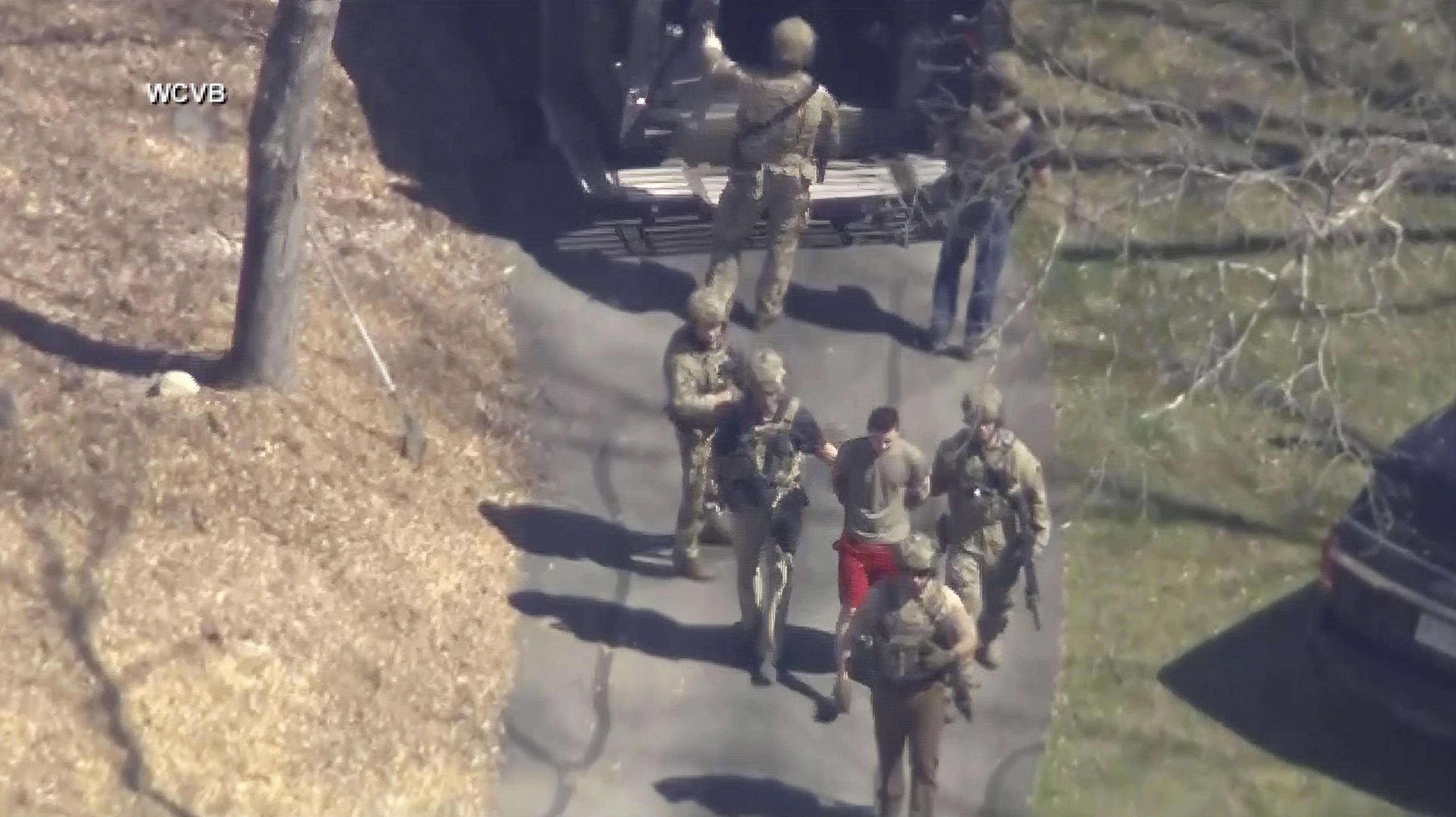 This image made from video provided by WCVB-TV, shows Jack Teixeira, in T-shirt and shorts, being taken into custody by armed tactical agents on Thursday, April 13, 2023, in Dighton, Mass. Photo / AP
