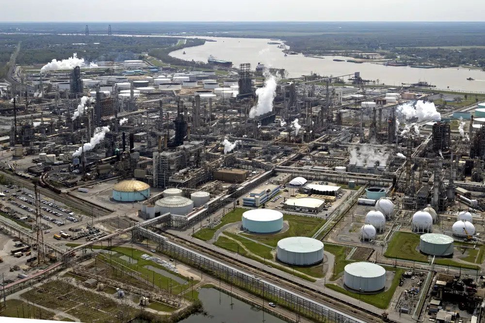 The Shell Norco refinery is seen along the Mississippi River in Norco, La., Thursday, March 8, 2018. The refinery is considered one of the largest petrochemical facilities in the United States. A growing number of companies are pledging to cut their greenhouse gas emissions to “net zero” to curb climate change, a new report finds the goal is rarely supported by a credible plan. (AP Photo/Gerald Herbert, File)