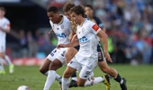 Xavier Bertoncello of the Jets competes for the ball with Dan Hall and Lachlan Brook of Auckland FC during the round 21 A-League Men match between Newcastle Jets and Auckland FC at McDonald Jones Stadium, on March 14, 2026, in Newcastle, Australia. (Photo by Scott Gardiner/Getty Images)