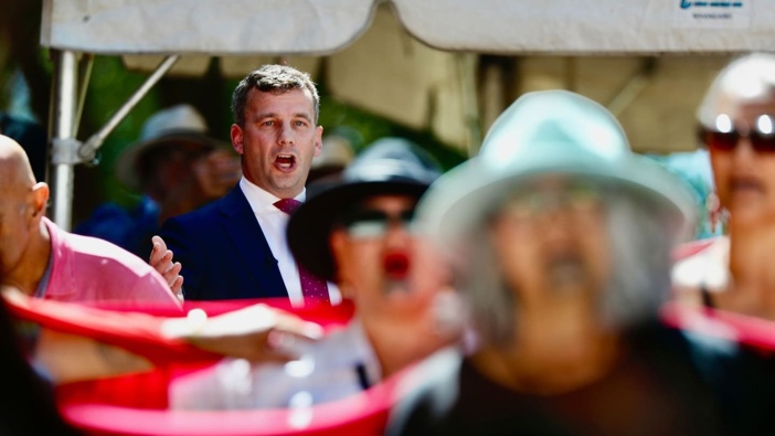 Protesters turn their backs on Act leader David Seymour during his speech at the Waitangi Treaty Grounds marae. Photo / Dean Purcell