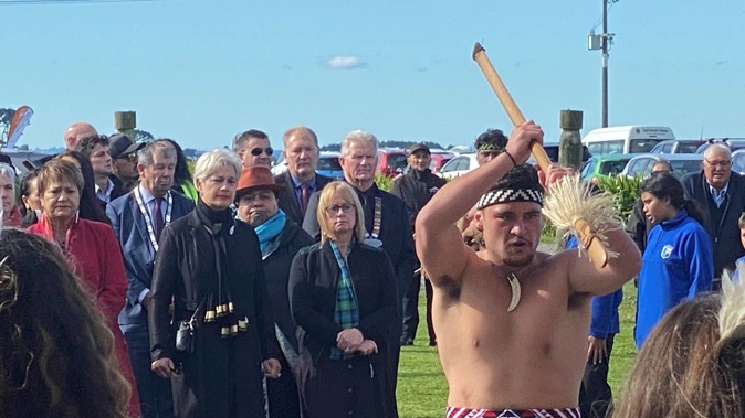 The Crown party is led into Ngakaunui Wharenui at Aotearoa Pā.
