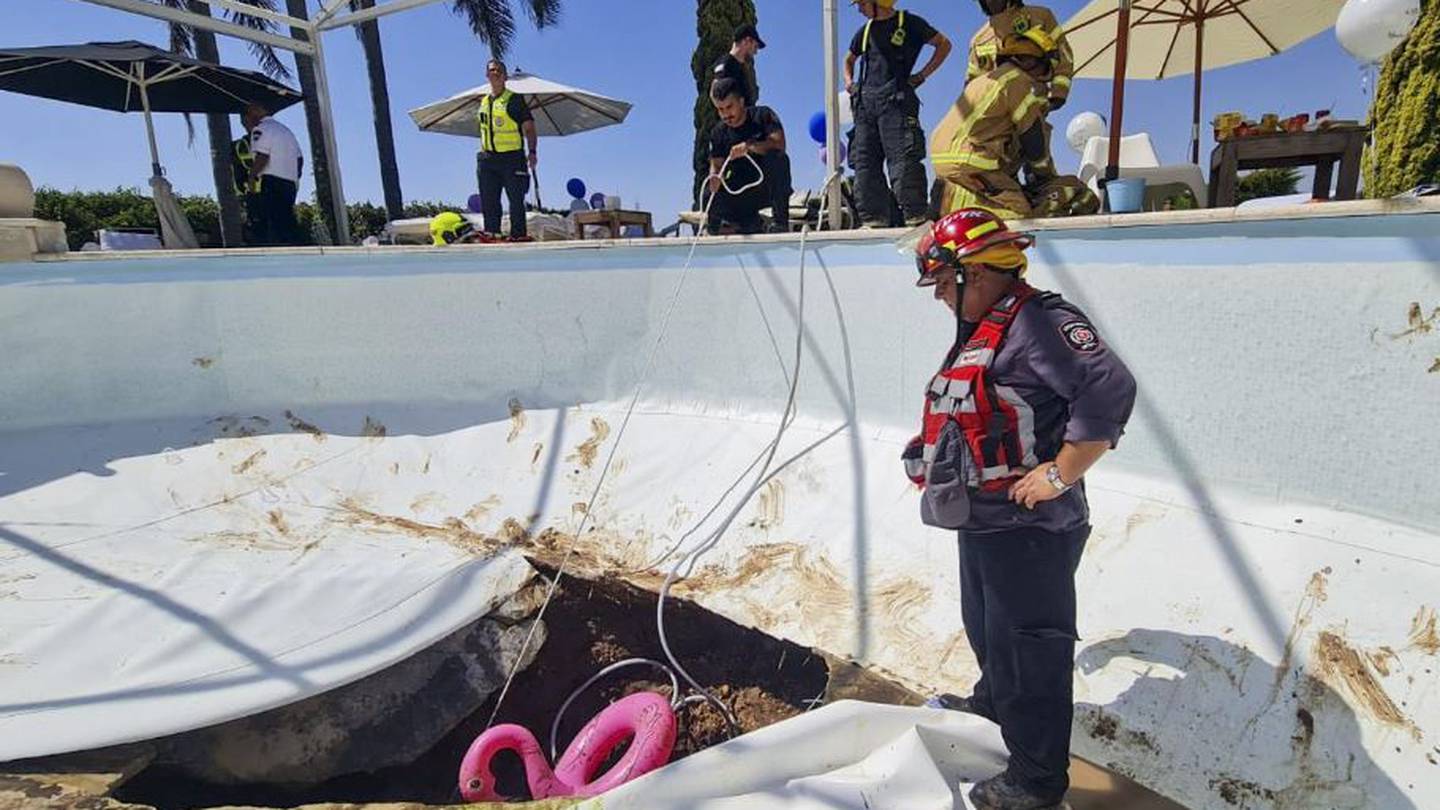 Firefighters and rescuers work in a sinkhole that formed in a swimming pool in Karmi Yosef, Israel. Photo / AP