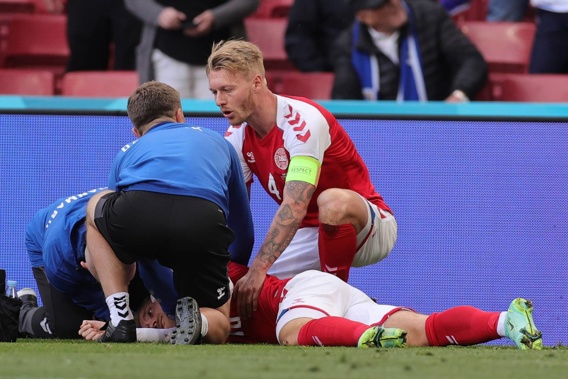 Denmark's Christian Eriksen lies on the ground after collapsing during the Euro 2020 soccer championship group B match between Denmark and Finland. Photo / AP