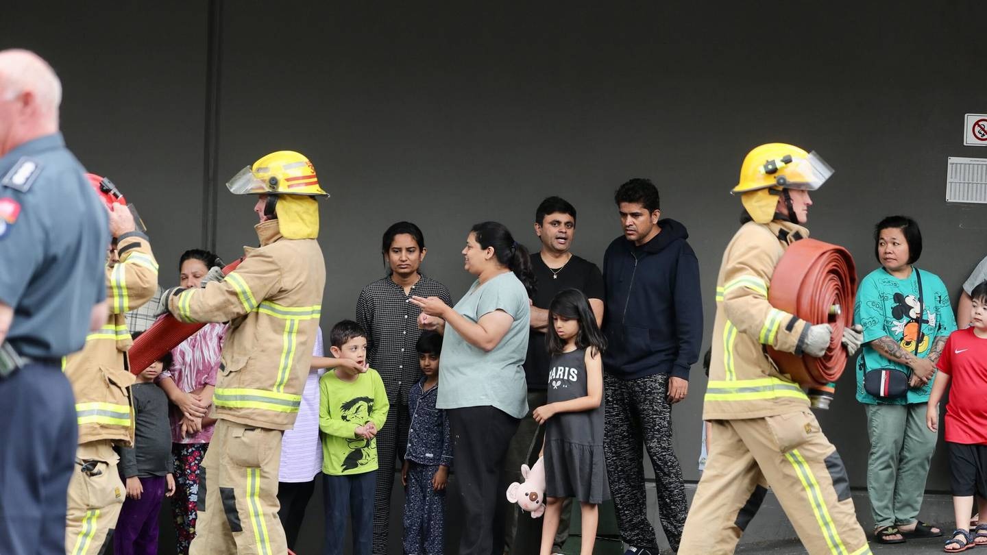 Evacuated residents outside the apartment building this morning. Photo / Jason Dorday