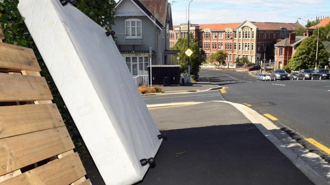 A bed base and pallets dumped in Stuart St, Dunedin. Photo / Stephen Jaquiery, ODT