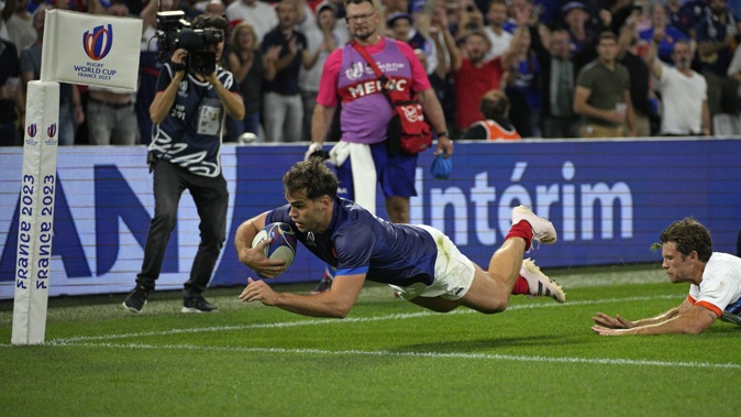 France's Damian Penaud dives over to score the opening try the Rugby World Cup Pool A match between France and Namibia. Photo / AP