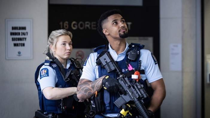 Armed police guarding the entrance to the Auckland Harbour’s Suites apartment complex in Gore St in central Auckland, 24 June 2024. Photo / Jason Oxenham