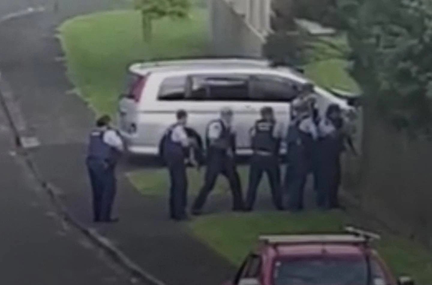 Police confront an armed man at the property, who was shot dead after opening fire at officers.