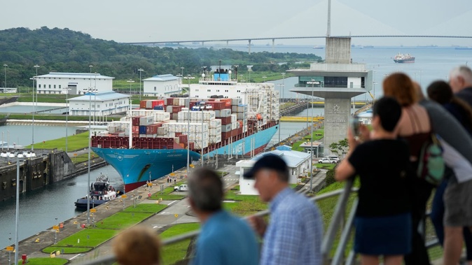 Tourists observe Danish cargo ship Lars Maersk sailing through the Agua Clara Locks of the Panama Canal in Colon City, Panama, on December 28. Photo / AFP