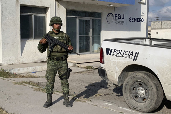 A Mexican army soldier guards the Tamaulipas State Prosecutor's headquarters in Matamoros, Mexico. Photo / AP