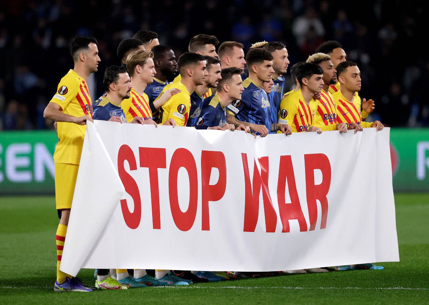 Barcelona and Napoli players hold a banner aloft before their Europa League fixture on Friday. (Photo / Getty)