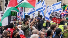 People take part in a pro-Palestine march as they walk past a counter-protest with Israeli flags, at Waterloo Place in central London. Photo / AP