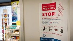 A poster at a medical centre warns against the spread of measles. Photo / Rob Dixon, RNZ