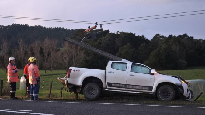 Top Energy line workers at the crash scene just north of Puketona Junction. Photo / Peter de Graaf