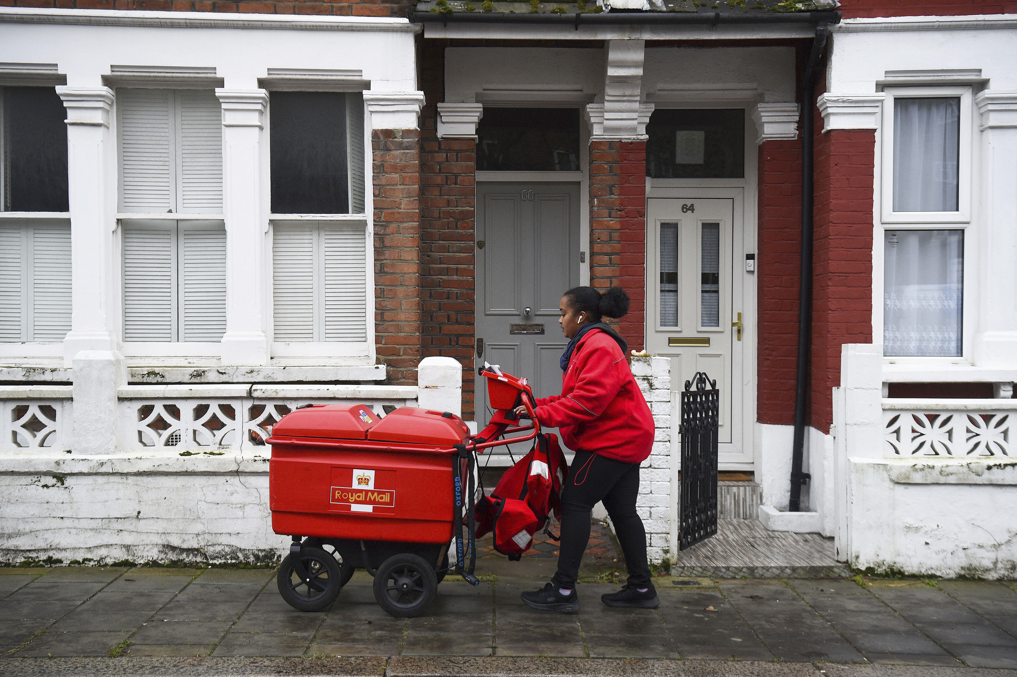 Royal Mail worker Leila delivers mail in Balham, London. Photo / AP