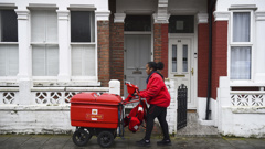 Royal Mail worker Leila delivers mail in Balham, London. Photo / AP