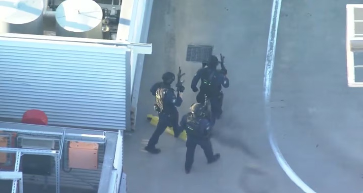 A still photo taken from 9 News coverage showed heavily armed police entering the mall from the roof after the alarm was raised. Photo / 9 News