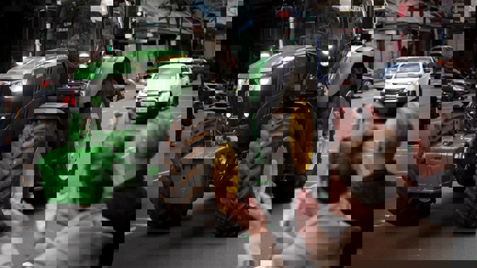A John Deere tractor rumbles along Queen St in Auckland during the Howl of a Protest event, organised by Groundswell New Zealand. (Photo / Greg Bowker)