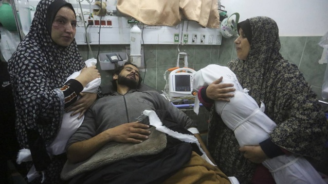 The Zoarab family grieve the loss of their newborn girl Amira and her 2-year-old brother Ahmed after their home collapsed on them in an Israeli airstrike. Their father was also injured in the blast and is here in hospital. Photo / AP