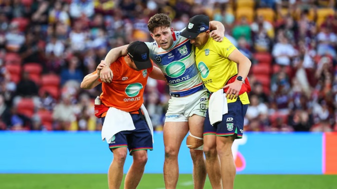Luke Metcalf is helped off the field. Photo / Photosport
