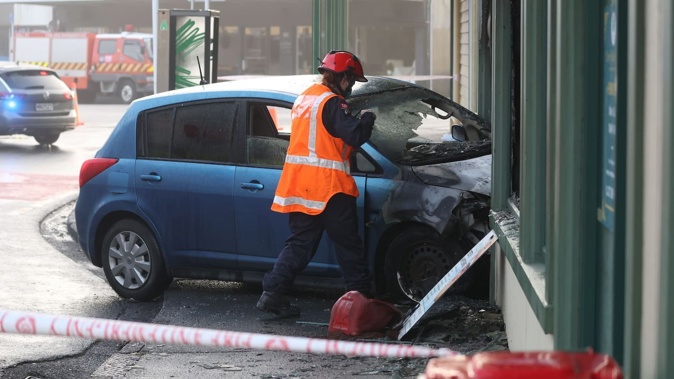 A car crashed into a property in Mt Eden, causing it and the building to catch fire this morning. Photo / Jason Oxenham