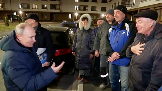 Putin talks with local residents during his visit to Mariupol. Pool/AP