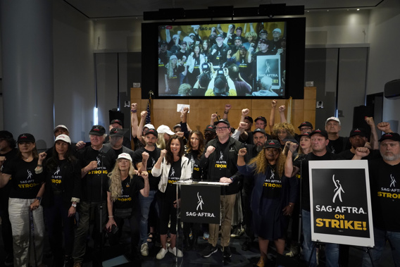 SAG-AFTRA president Fran Drescher and SAG-AFTRA National Executive Director and Chief Negotiator Duncan Crabtree-Ireland, center, pose with SAG-AFTRA members during a press conference announcing a strike by The Screen Actors Guild-American Federation of Television and Radio Artists on Thursday, July, 13, 2023, in Los Angeles. Photo / AP