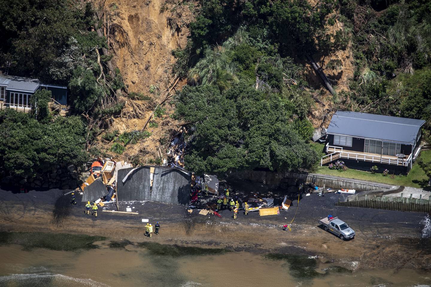 Three people were injured after a building collapsed in Orua Bay Beach at Manukau Heads on February 1. Photo / Michael Craig