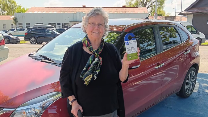 Barbara Barwick displays her mobility card while parked in one of the disability car parks outside Gisborne District Council. Motorists who abuse the blue-coloured disability car parks are liable to be issued an increased fine of $750, effective from Tuesday. Photo / Wynsley Wrigley