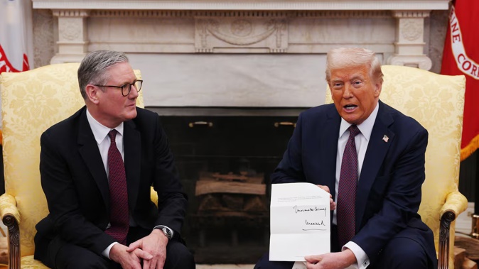 UK Prime Minister Keir Starmer hands an invitation from King Charles for a second state visit to US President Donald Trump at the White House on February 27. Photo / Getty Images
