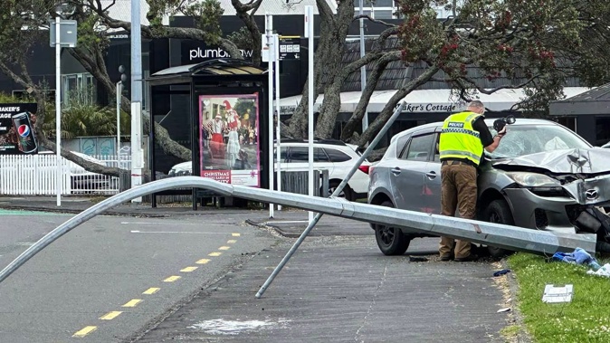 Police inspect a car involved in an accident on New North Road in Kingsland in which a pedestrian was hit. Photo / Julian Bravery