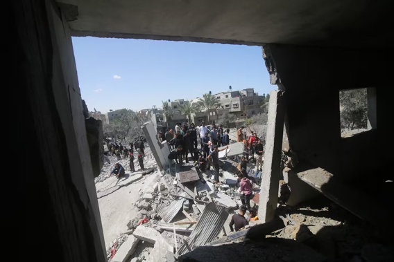 Palestinians look at a residential building destroyed in an Israeli strike in Rafah, Gaza Strip, Tuesday, March 20, 2024. Photo / AP