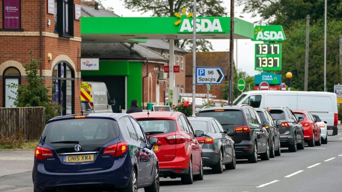 Cars queue outside a petrol station in Reading, England. (Photo / AP)