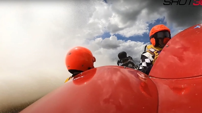 Ross Christensen and Adam Smale in the jet boat Under Seige as it plunges underwater. Photo / YouTube