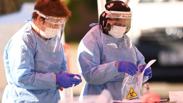 Health workers perform duties at a pop up Covid-19 testing clinic at Eight Miles Plains in Brisbane's south. (Photo / News Corp Australia)
